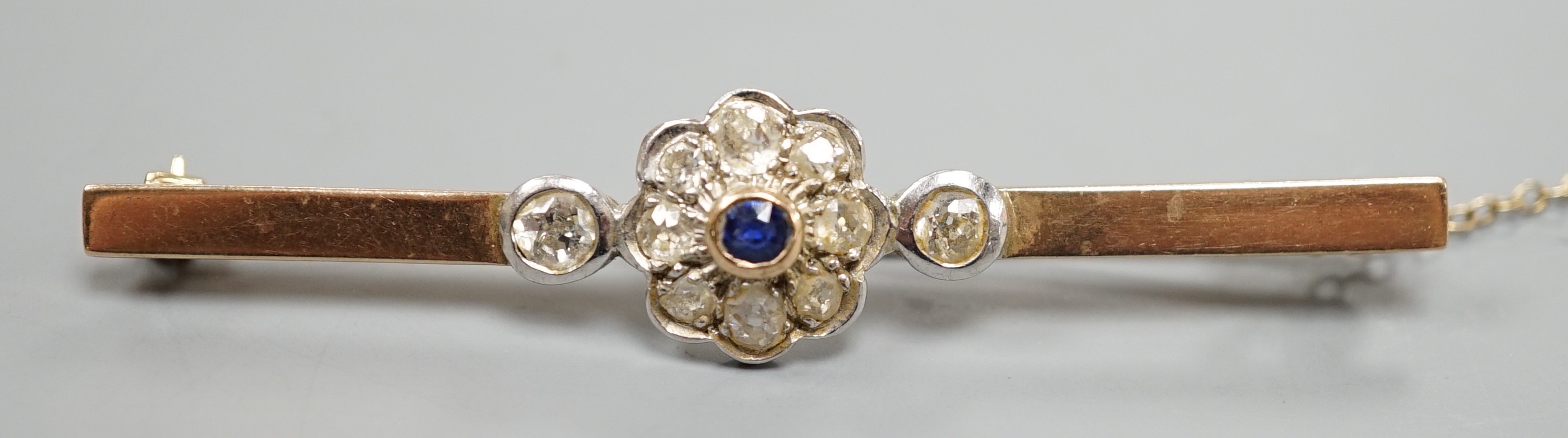 A 9ct, sapphire and diamond cluster set bar brooch (possibly converted), 65mm, gross weight 5.7 grams.